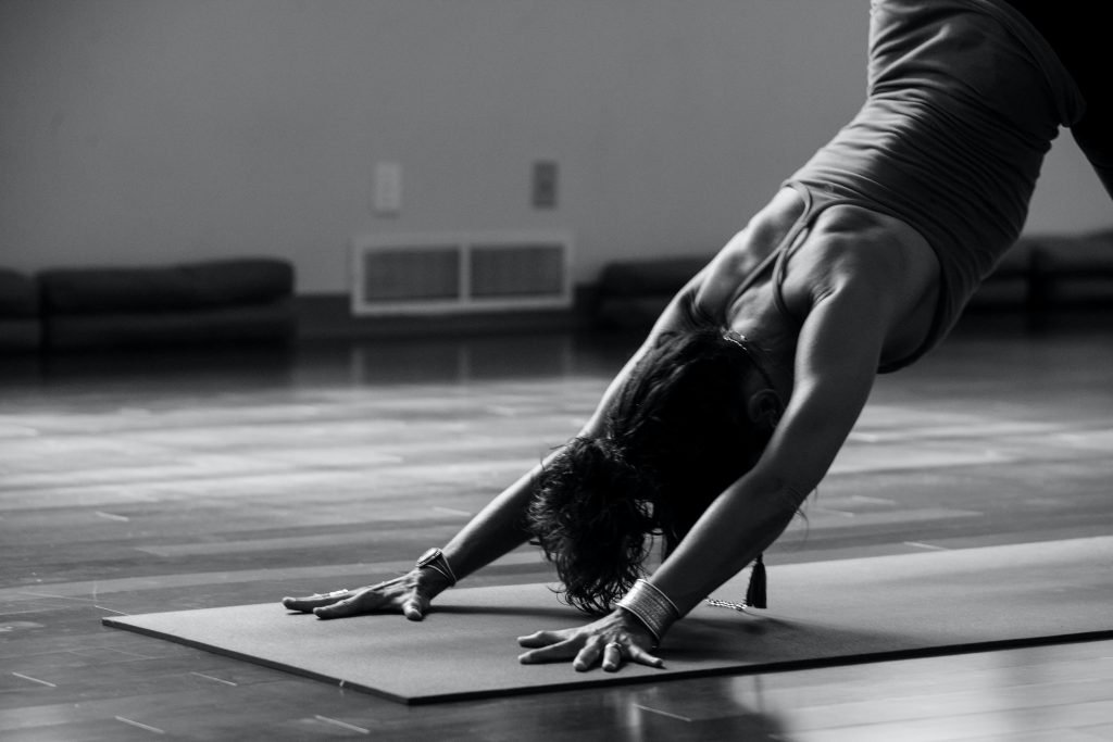 a black and white image of a yogi in down dog pose in ashby-de-la-zouch